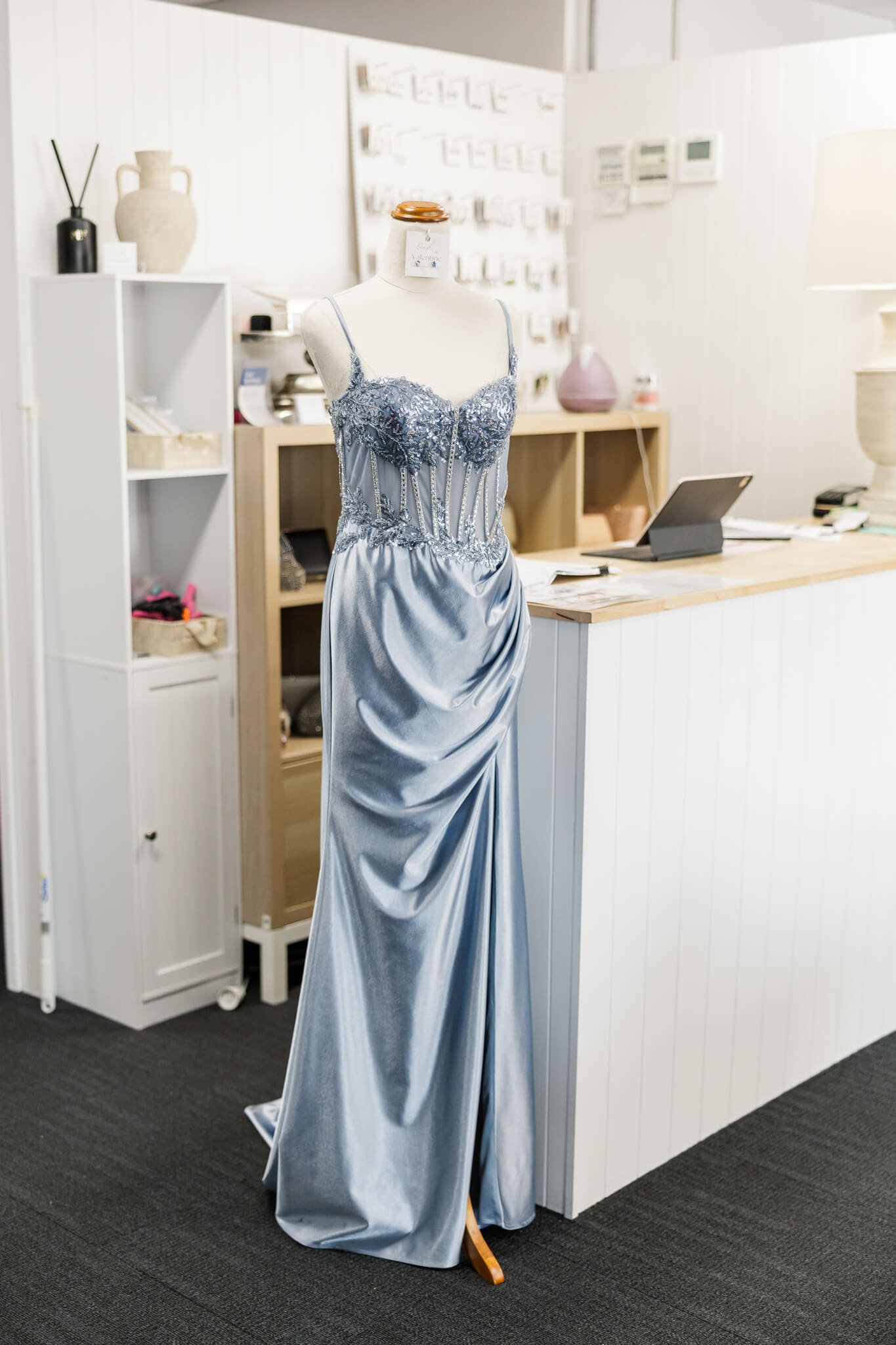 Inside the store of a wedding dress shop in Rockhampton featuring a mannequin wearing a blue formal gown.