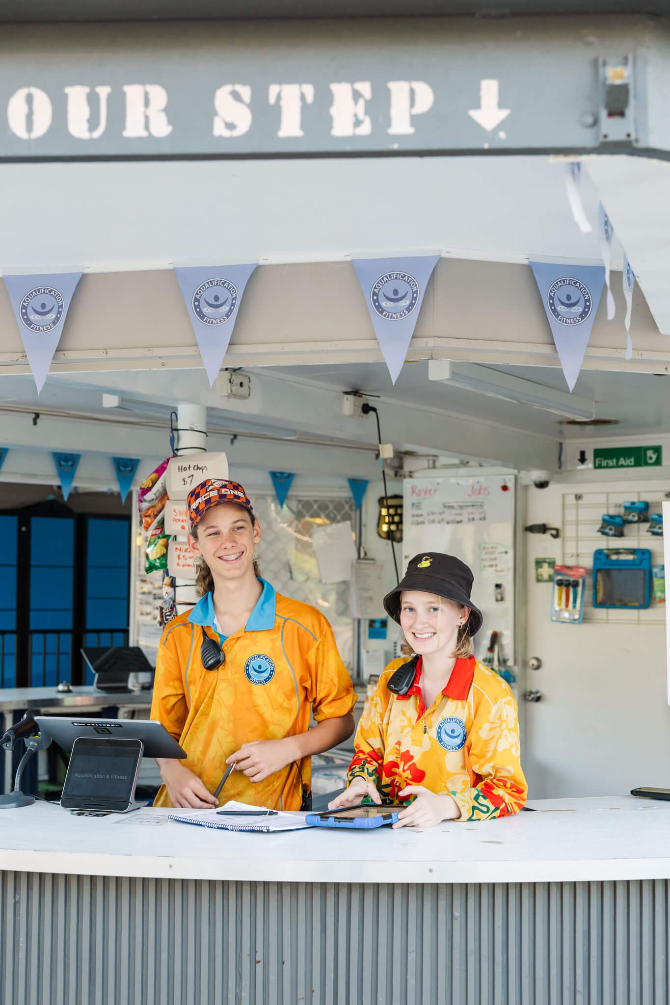 Staff at a local pool, smiling for the camera for a photo to be used for website design in Rockhampton.