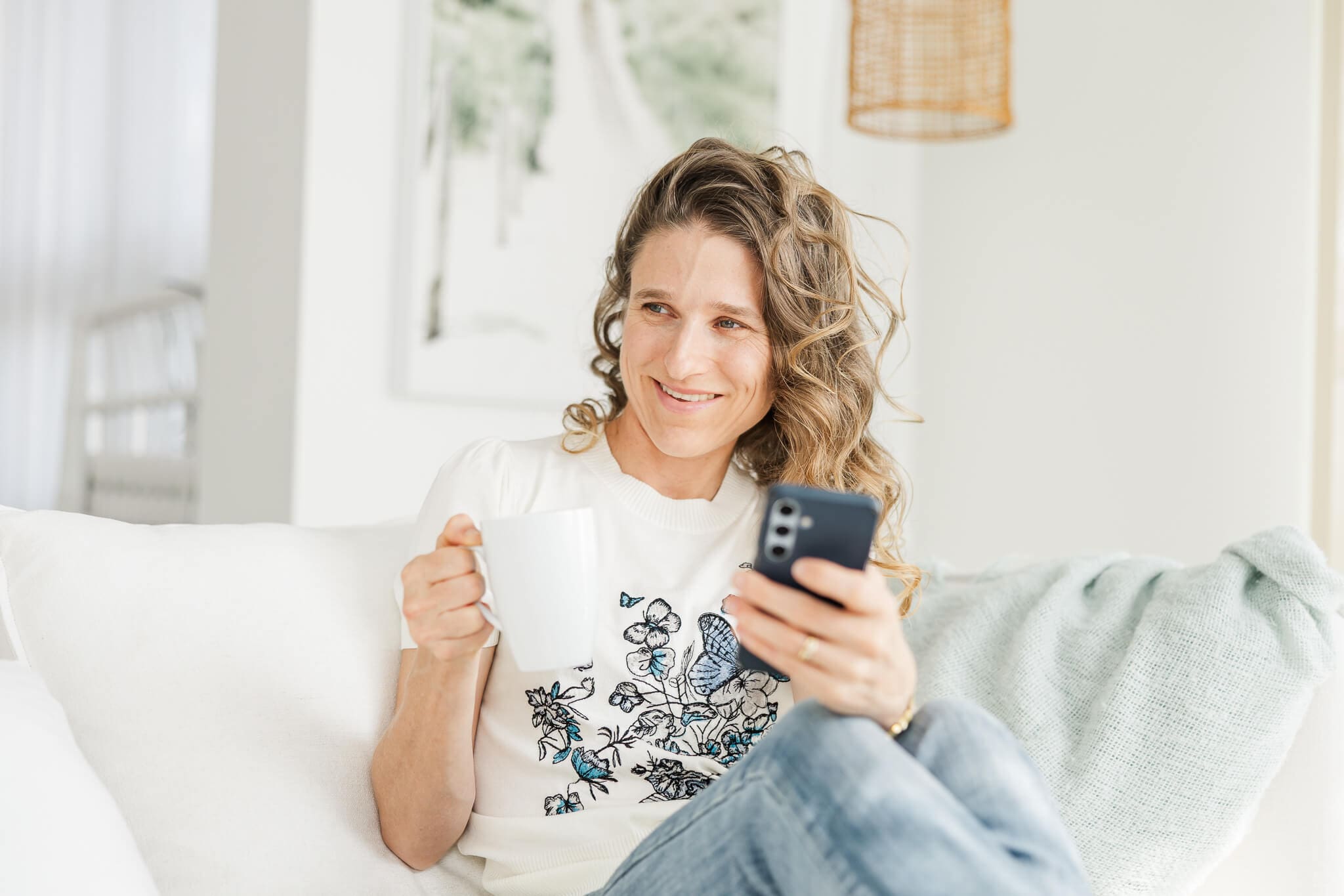 Julie-Anne Photography branding photo of her holding her phone and a coffee cup.