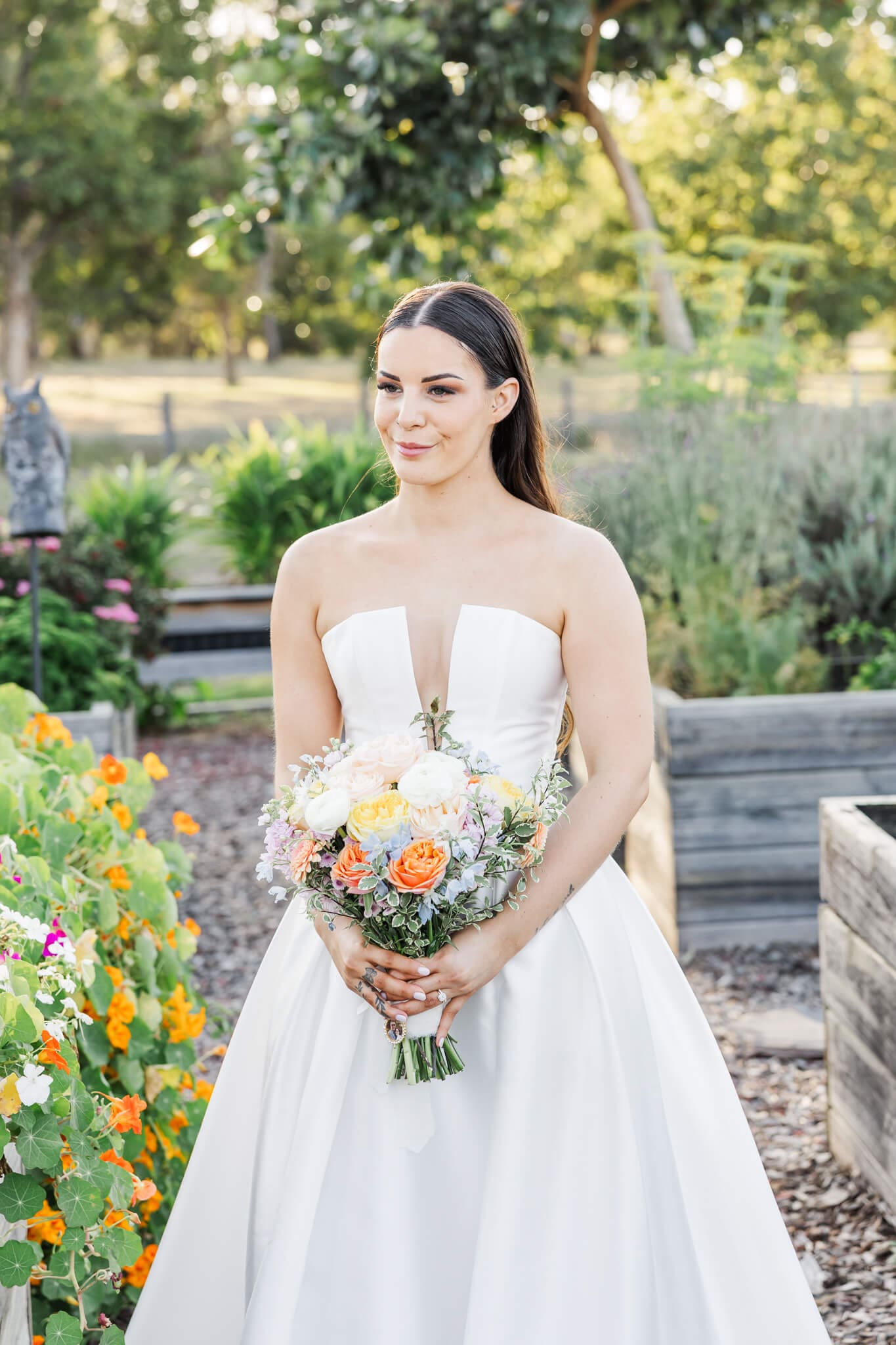 Elegant portrait of a bride holding her bouquet in a beautiful garden. Florals by Dusty Blooms, a Yeppoon Florist.