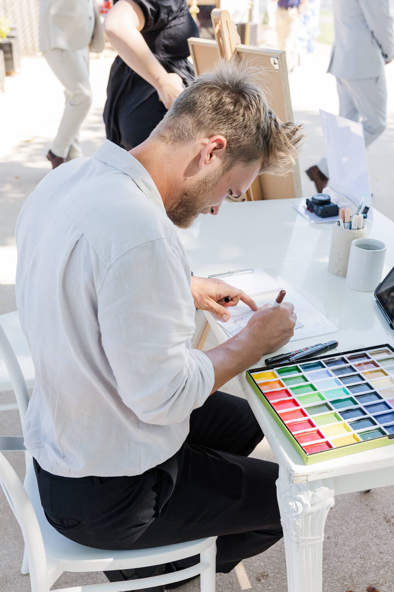 An artist doing live guest paintings at a Yeppoon wedding.