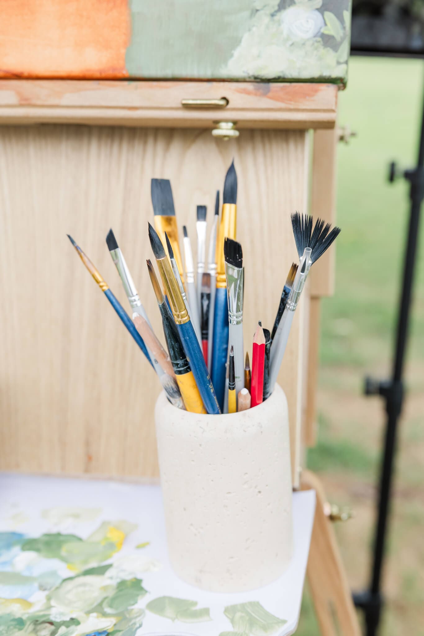 Detail shot of an artist's jar of paint brushes.