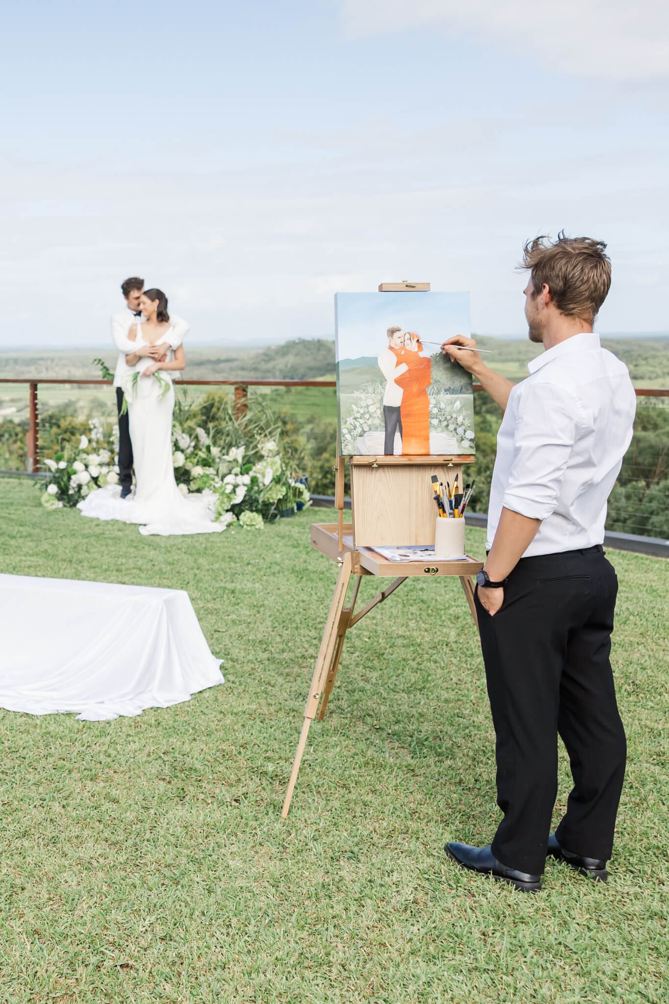 Art by Joel in action, painting a couple in a Rockhampton and Yeppoon venue.