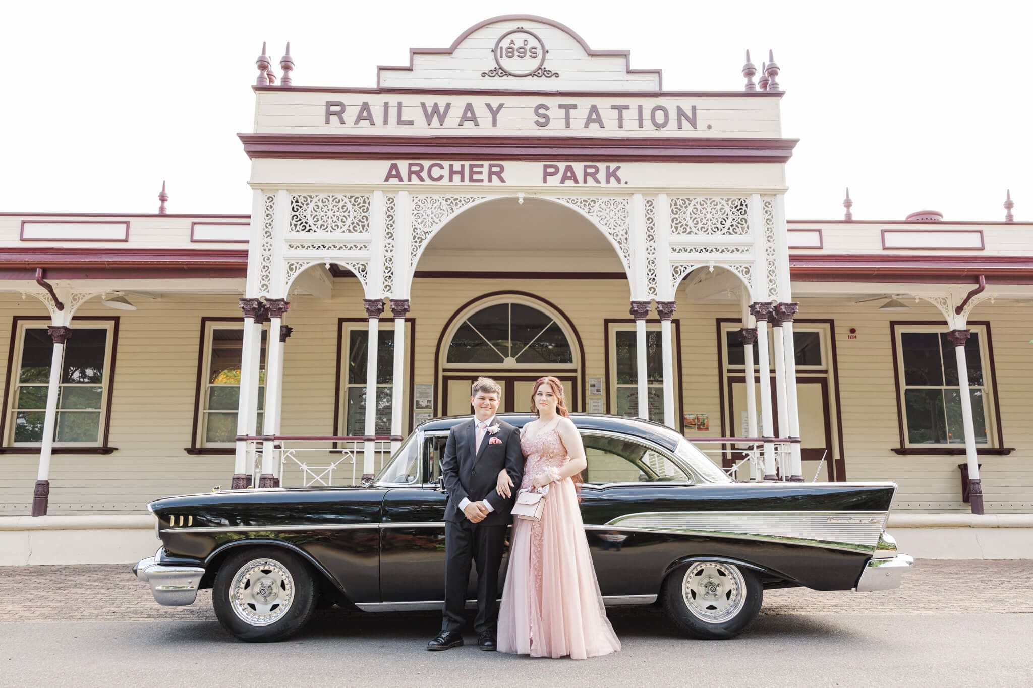Formal graduates and their car hire in Rockhampton, posing for their formal photos.