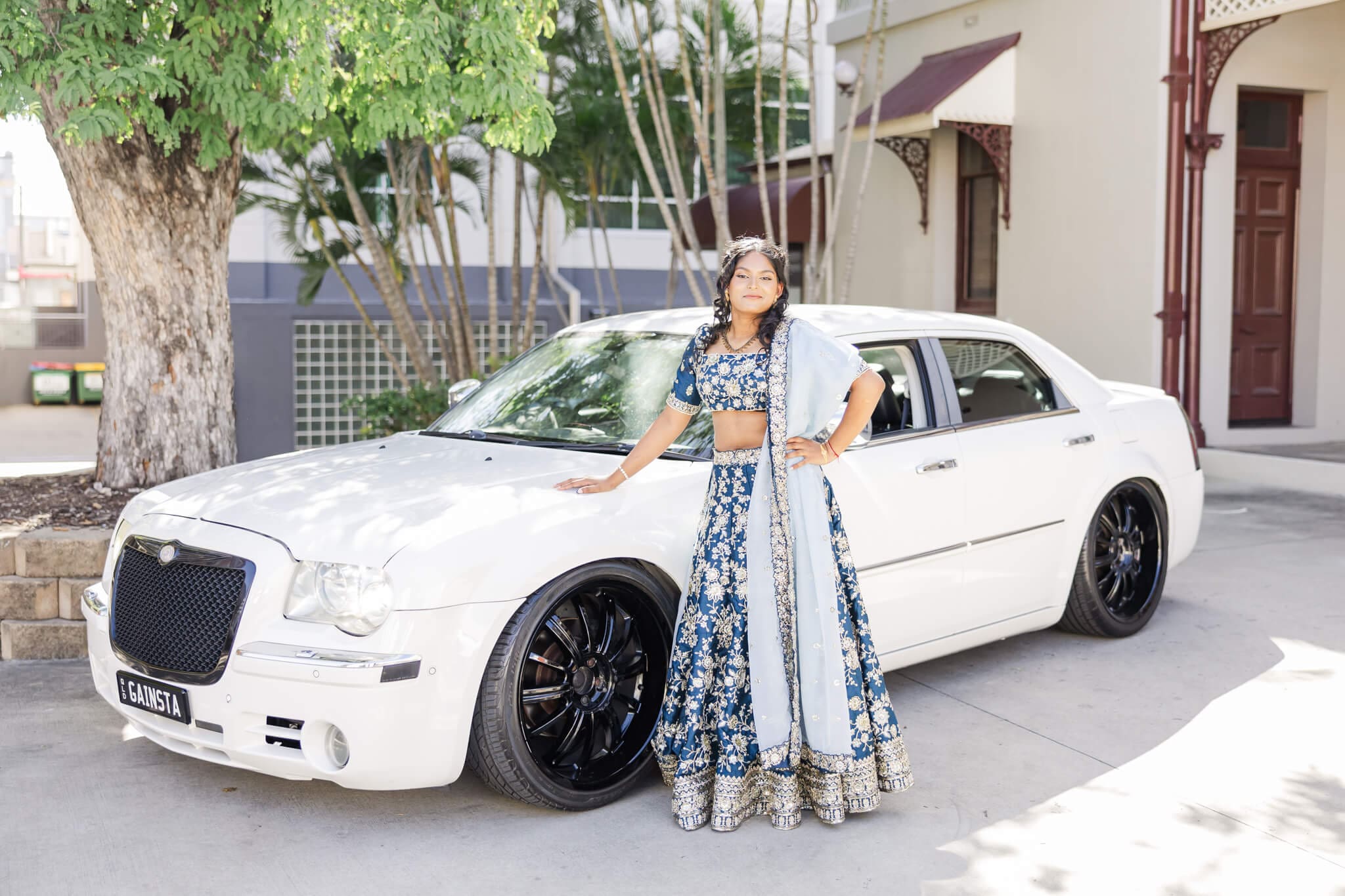 High school senior poses for her formal photos, next to her car hire in Rockhampton. Image by Julie-Anne Photography.
