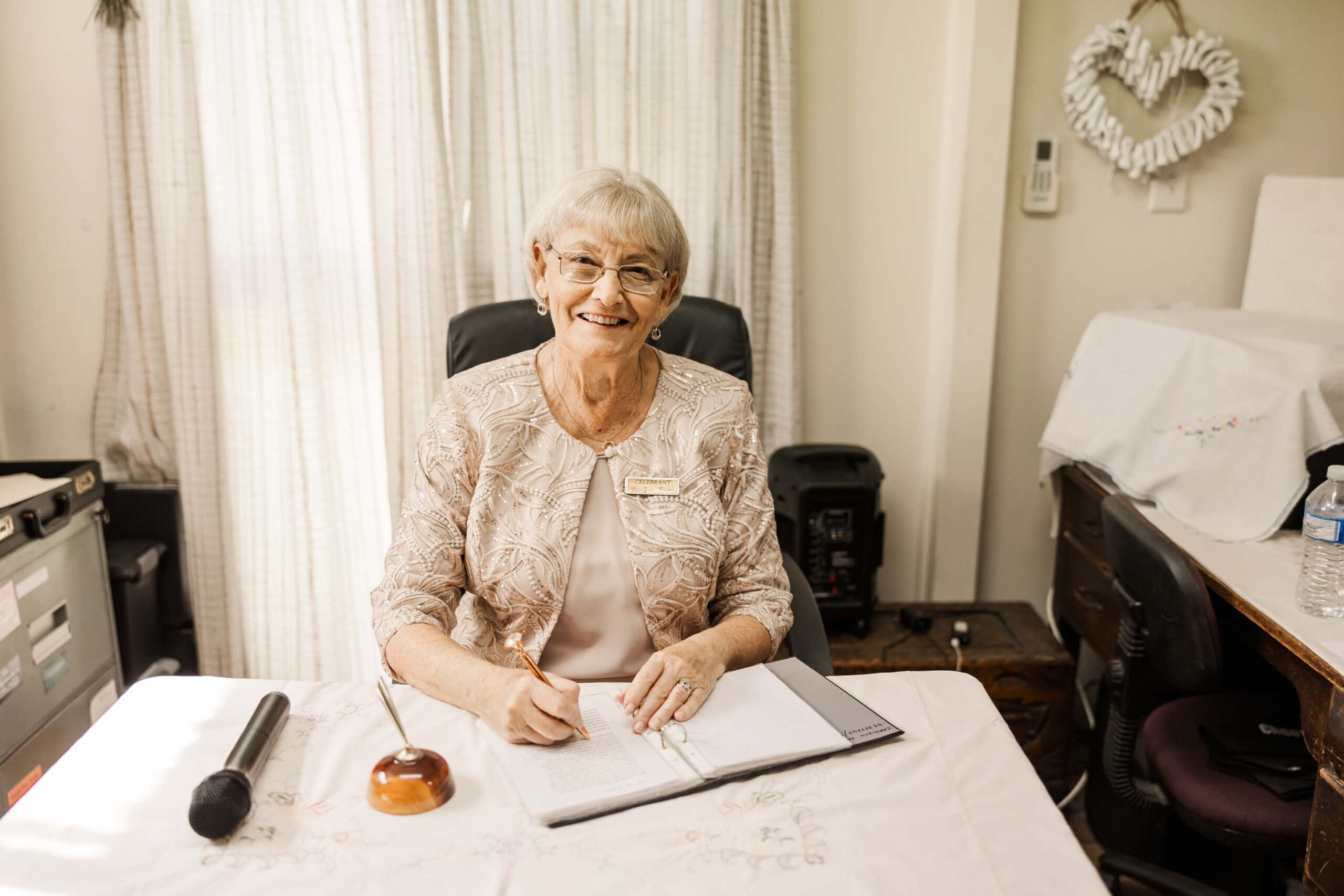 A Rockhampton and Yeppoon marriage celebrant sits in her office, waiting to chat to a bride and groom about their wedding day.