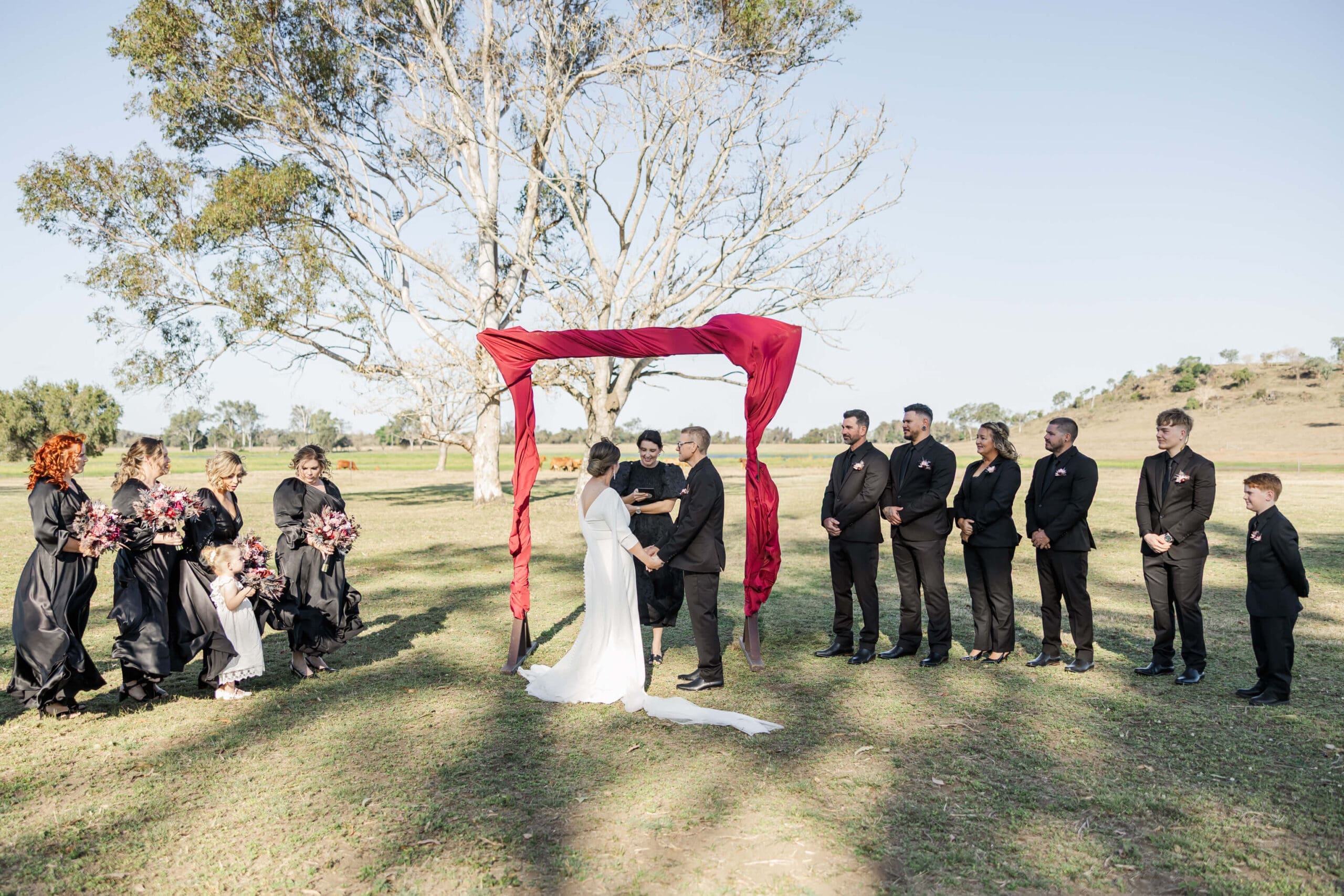 Krystal Feather marries a bride and groom in a country style wedding in a Central Queensland paddock.