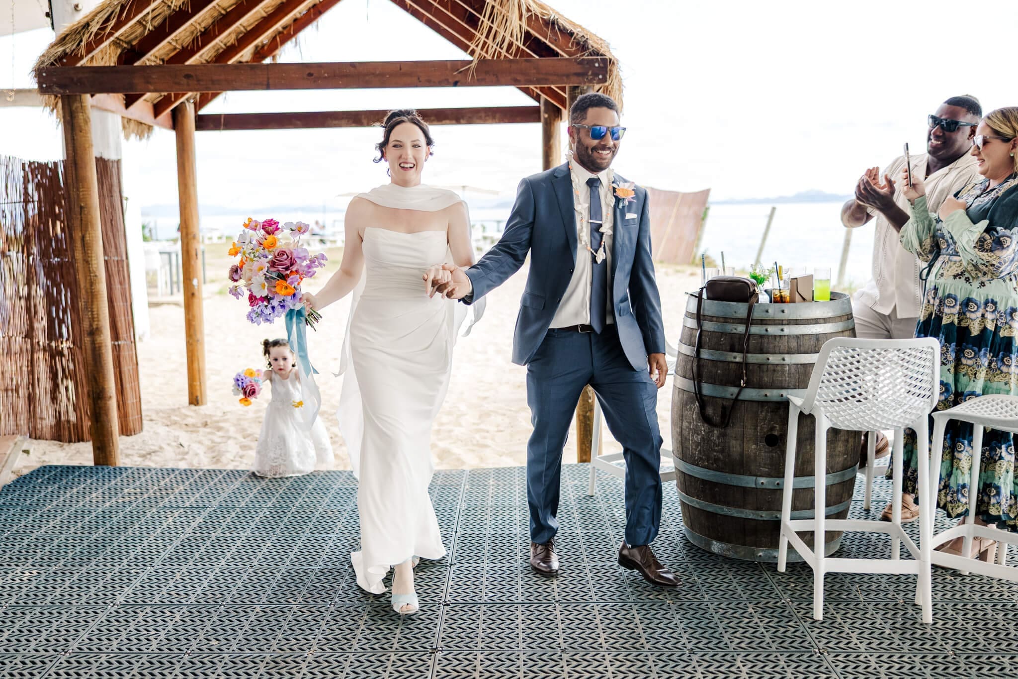 Bride and Groom dressed in their finest, enter their wedding reception.