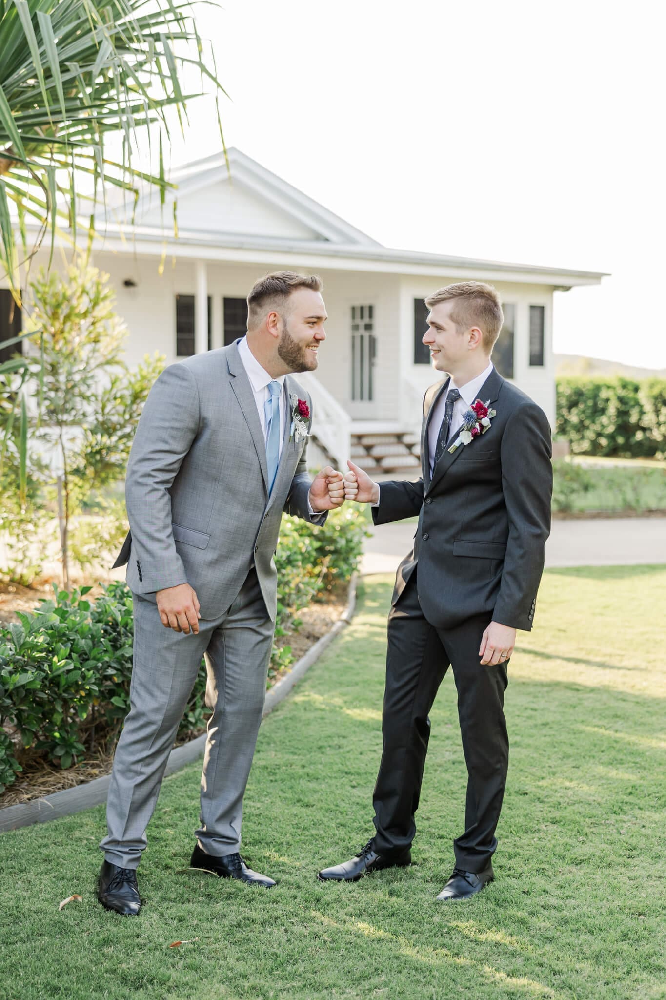 Groom and his best man have a laugh during cocktail hour on wedding day.