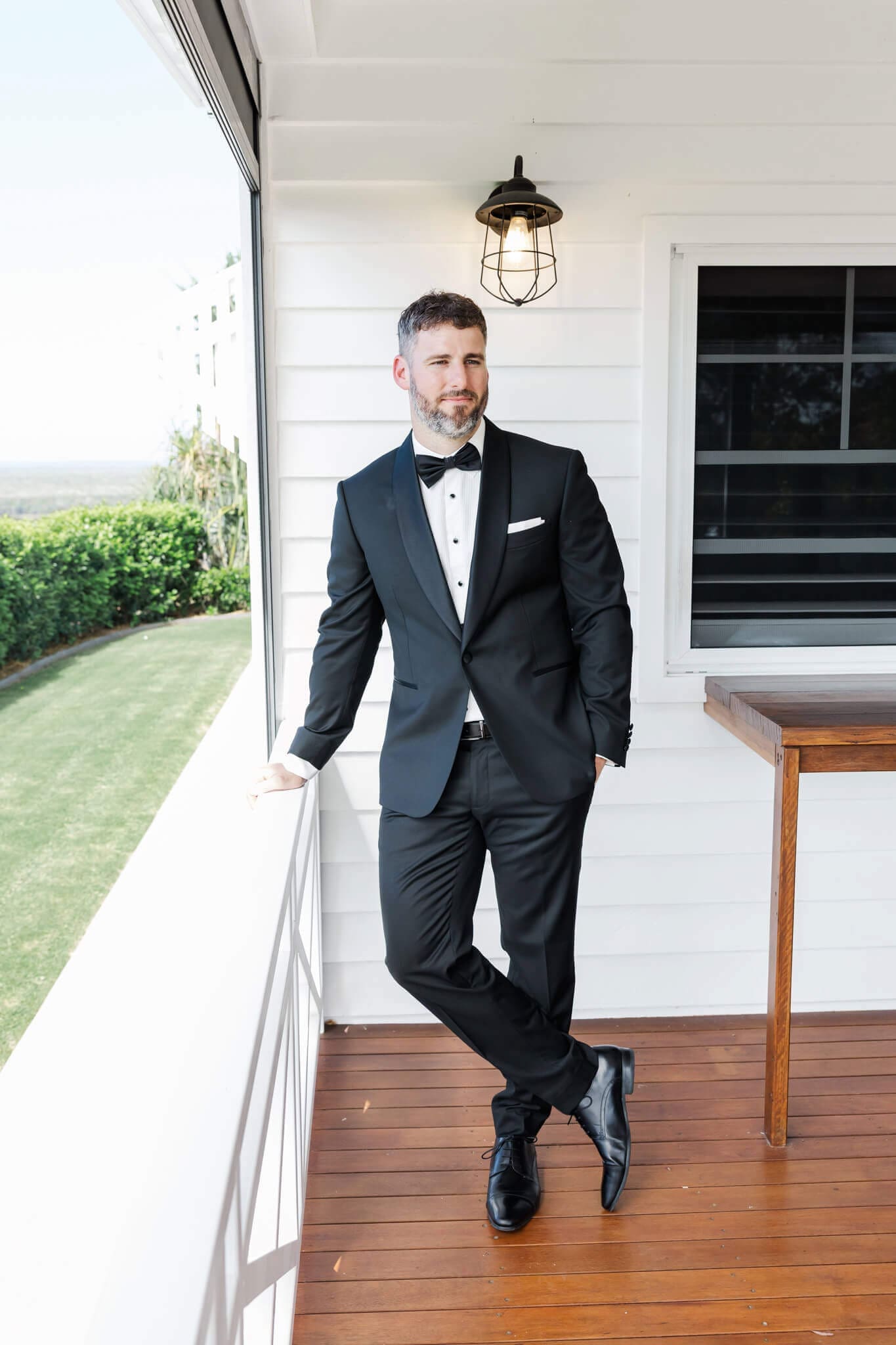 Groom stands relaxed on his wedding day, before his ceremony.