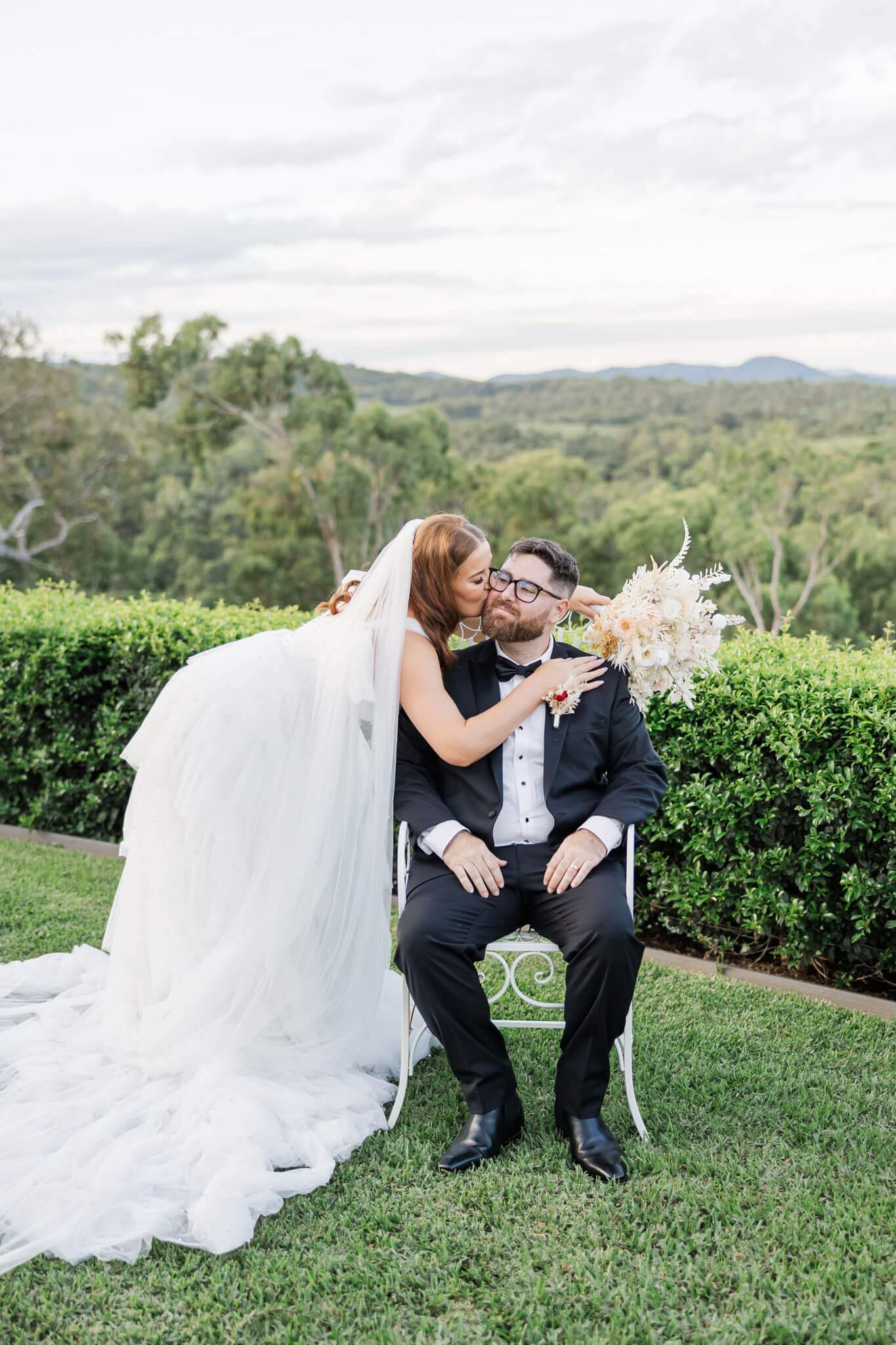 Bride kisses the groom who is dressed in a suit purchased from Rockhampton.