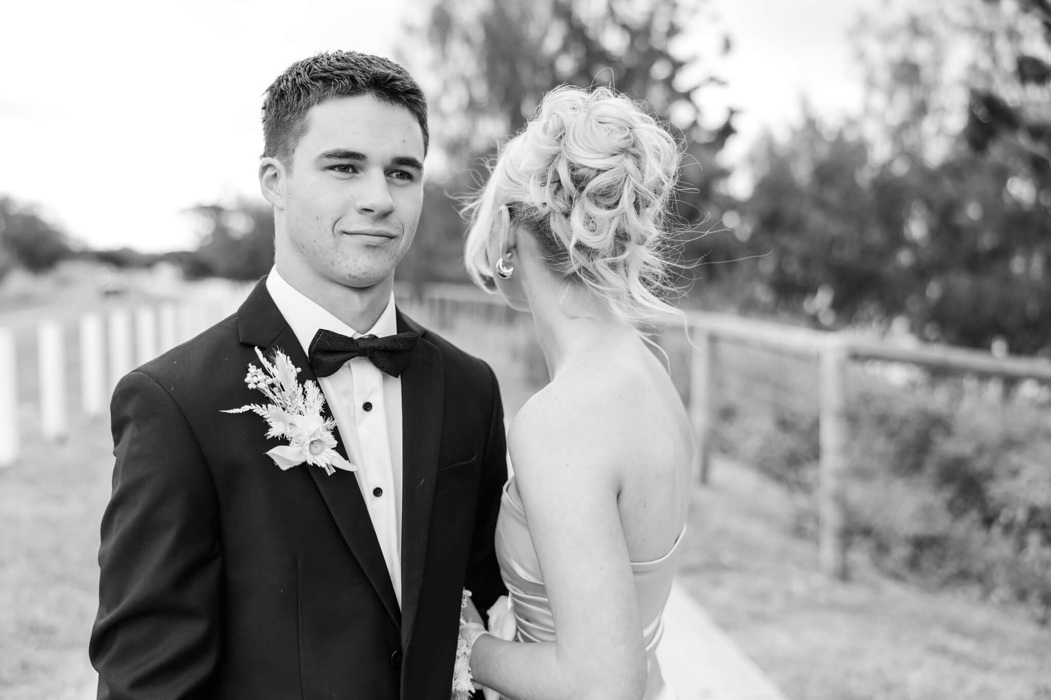 A high school graduate posing for photos with his partner, near Yeppoon for his formal photos.