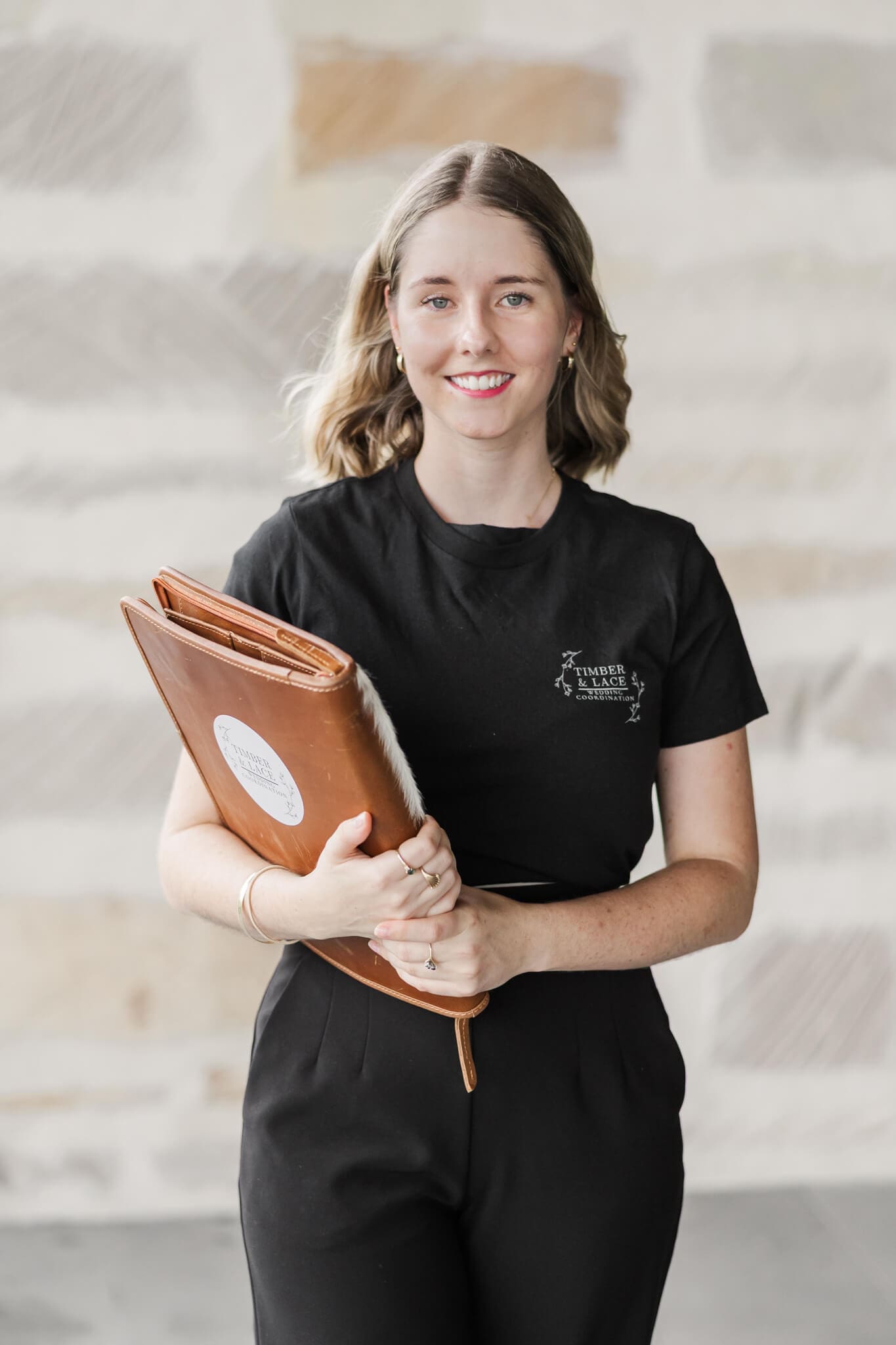 Shelby, owner of Timber and Lace Coordination, poses for a headshot, taken by Julie-Anne Photography.