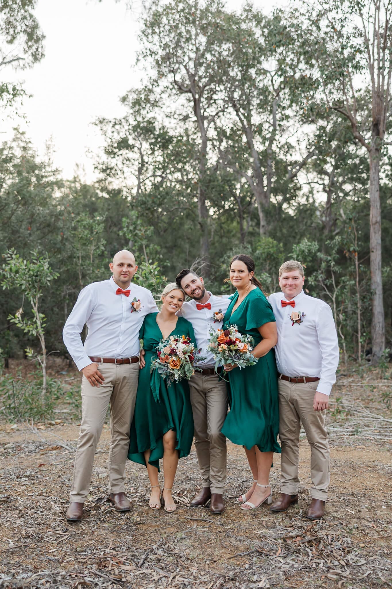 Bridal party pose for their group shot in a rural setting amongst Australian Bush.
