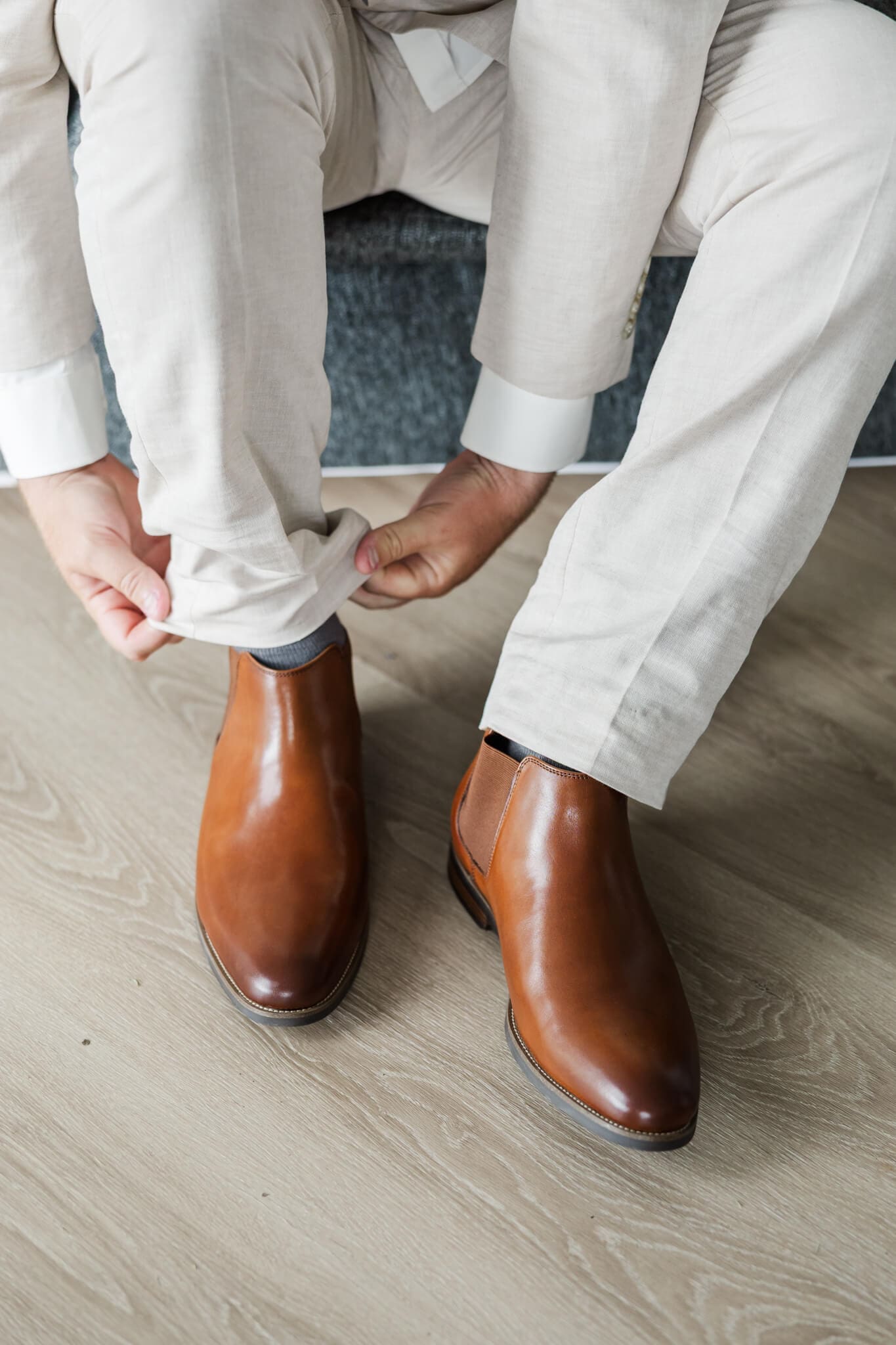 Detail shot of groom's boots as he puts them on.