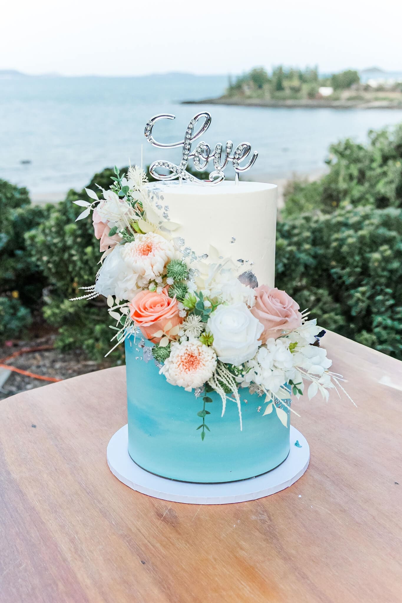 Wedding cake all set up outdoors at The Haven Yeppoon, a wedding venue near Emu Park.